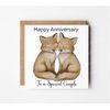 Anniversary card featuring two cute foxes sitting together with their tails forming a heart shape and the message Happy Anniversary To A Special Couple.